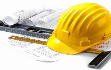 isolated hard hat with blueprints and rulers on white